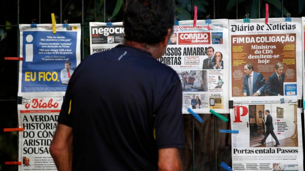 A man reads the front pages of various newspapers in Lisbon, where Portuguese media reported that two more government ministers were preparing to tender their resignation on Wednesday. Photograph: Hugo Correia/Reuters.