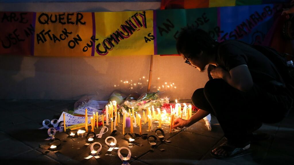 A man lights a candle for the victims of the Pulse gay nightclub in Orlando outside the US embassy in Bangkok, Thailand. Photograph: EPA/DIego Azubel