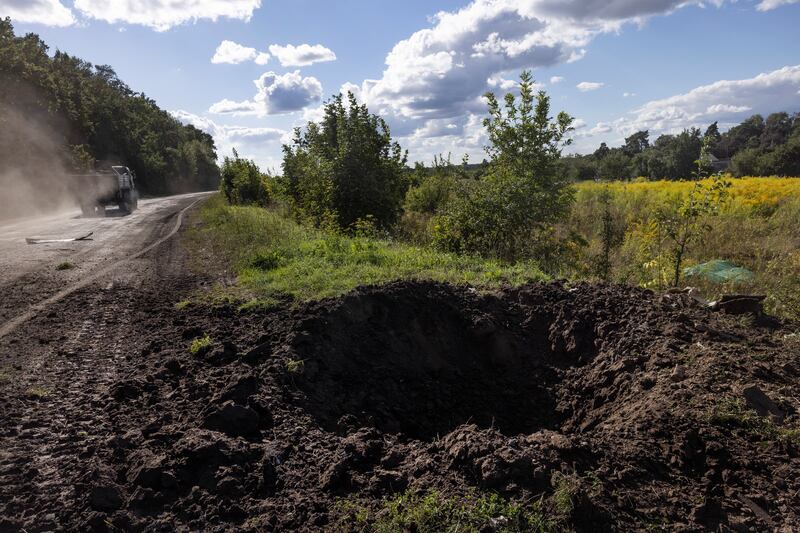 A Ukrainian military vehicle passes a roadside crater minutes after a Russian strike near the border in the Sumy region of Ukraine, on Tuesday. Photograph: David Guttenfelder/New York Times