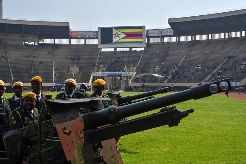 Zimbabwe soldiers prepare ceremonial canons to be used in rendering a gun salute, at the funeral. Photograph: Tony Karumba/AFP/Getty