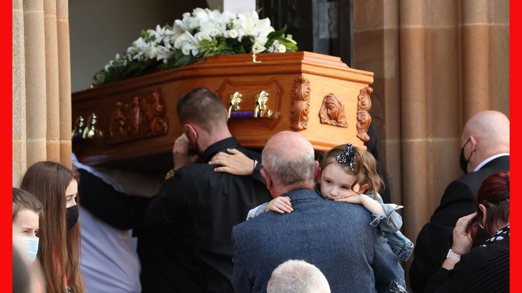 One of Samantha Willis’s daughters, Lilyanna, is carried into St Columb’s church, Derry, behind the coffin for the funeral of the mother of four from Strathfoyle who died with Covid-19 on Friday. Photograph: Liam McBurney/PA Wire