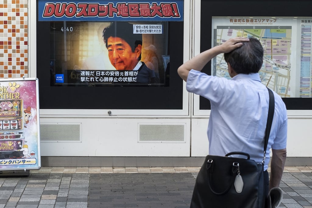A man in Tokyo looks at a television broadcast on the attack on former Japanese prime minister Shinzo Abe. Photograph: Charly Triballeau/AFP via Getty