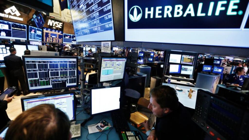 Traders work at the post that trades Herbalife stock on the floor of the New York Stock Exchange. KPMG resigned as the auditor of Herbalife Ltd after one of its senior partners engaged in insider trading in Herbalife stock. Photograph: Brendan McDermid/Reuters