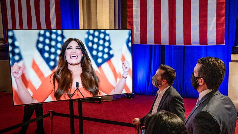 Donald Trump jnr, right, watches Kimberly Guilfoyle address the Republican National Convention. Photograph: New York Times