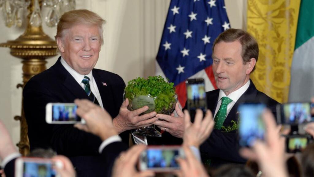 US president Donald Trump accepts a bowl of shamrock from Taoiseach Enda Kenny at the White House in Washington, DC, on March 16th. Photograph: Olivier Douliery/EPA