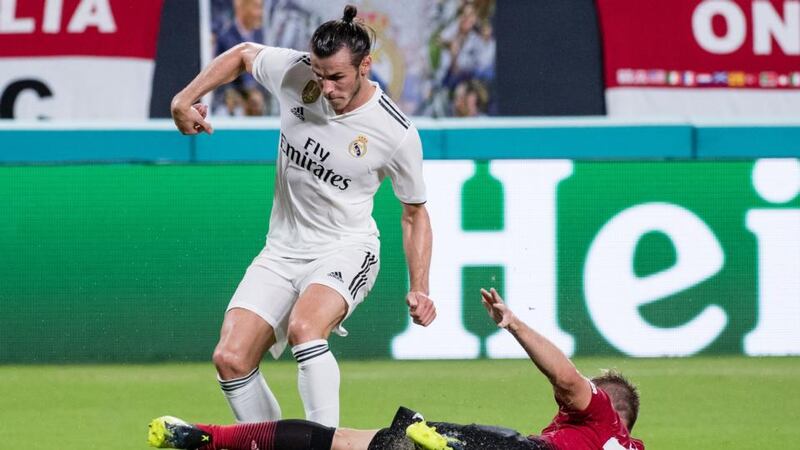 Luke Shaw gets a tackle in on Gareth Bale. Photo: Rob Foldy/Getty Images