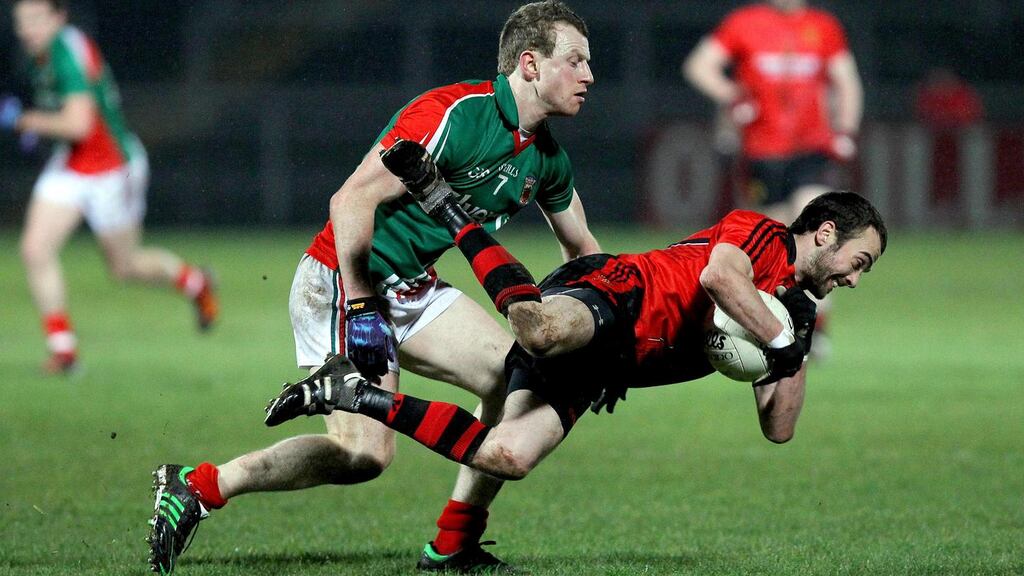 Down's Conor Laverty is challenged by Mayo's Colm Boyle. Photograph: William Cherry/Inpho