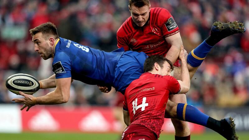 Leinster’s Jack Conan is tackled by Rory Scannell and Darren Sweetnam of Munster during the Guinness Pro 14 game atb Thomond Park. Photograph: Dan Sheridan/Inpho