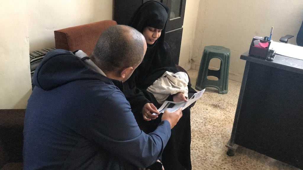 ITV News security editor Rohit Kachroo shows Shamima Begum a copy of the home office letter revoking her British citizenship in a refugee camp in Syria. Photograph: ITV News/PA Wire