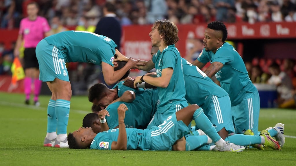 Real Madrid players celebrate Karim Benzema winner in Seville. Photograph: Getty Images