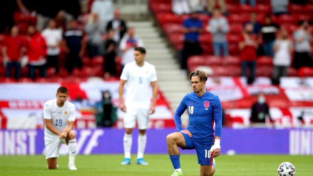 England’s Jack Grealish takes a knee as Romania’s Ionut Nedelcearu stands ahead of the international friendly match at Riverside Stadium. Photograph: Nick Potts/PA