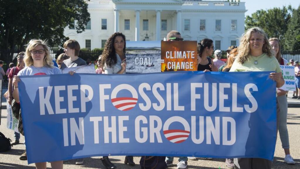 Activists at the White House protest over the Obama administration’s plans to allow new fossil fuel drilling. Photograph: Saul Loeb/AFP/Getty Images