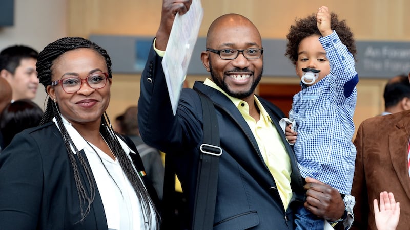 Damilo Mbaeru from Nigeria, with Filipe Kebana with his son Eric from Angola after the Irish Citizen Ceremony at the Convention Centre. Photograph: Cyril Byrne/The Irish Times