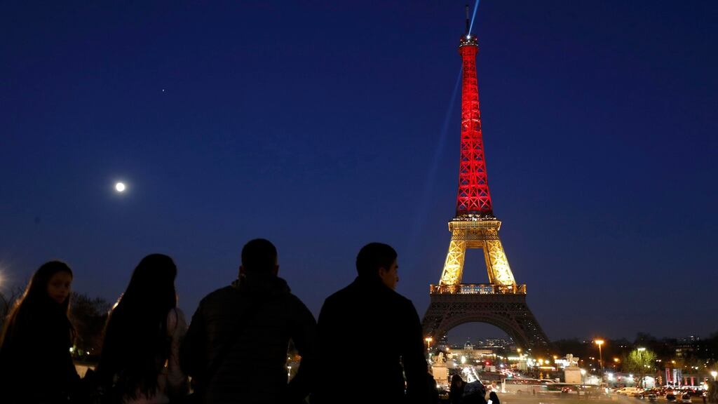 The Eiffel Tower with the black, yellow and red colours of the Belgian flag. Photograph: Philippe Wojazer/Reuters
