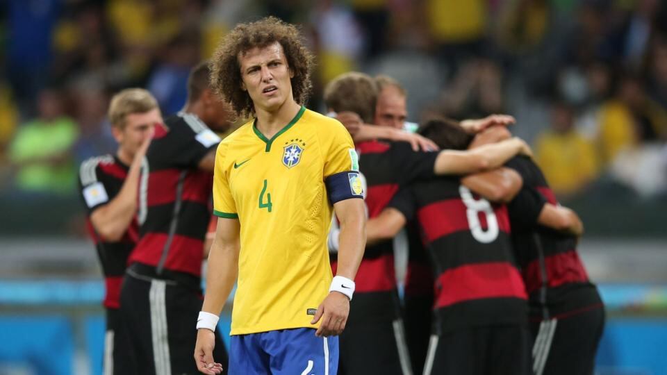 Brazil’s captain David Luiz beleaguered as German players celebrate at the Estadio Mineirao in Belo Horizonte. Photograph: Fernando Bizerra Jr / EPA