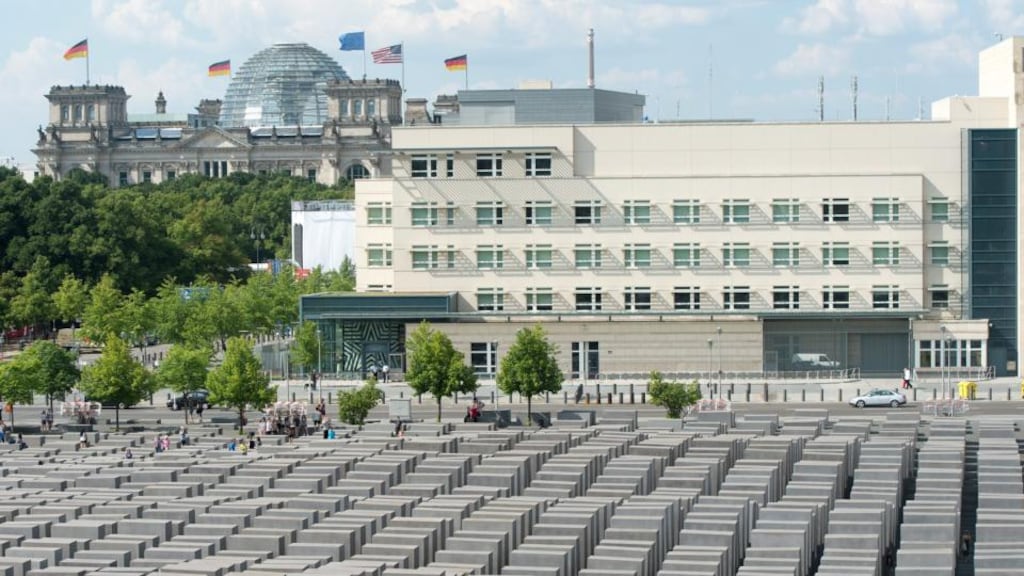 A view of the US embassy with the US flag showing the German Reichstag building in the background and the Holocaust memorial in the foreground in Berlin. Photograph: EPA