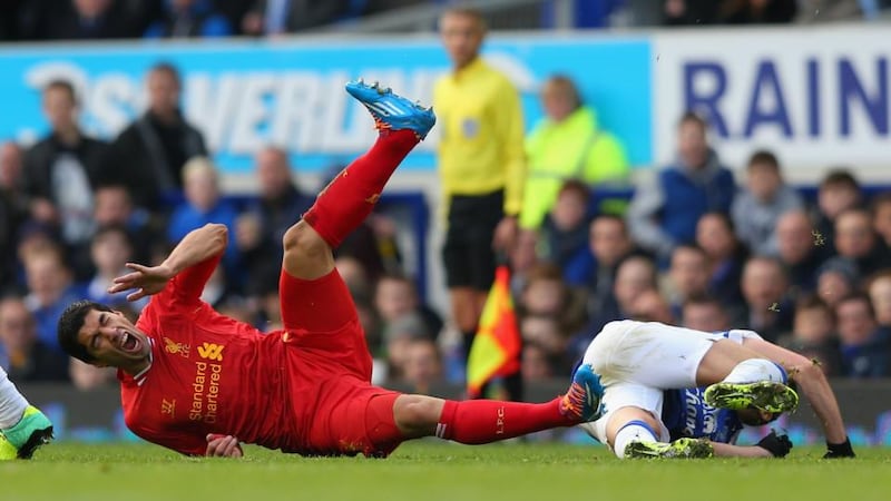 Luis Suarez of Liverpool after being fouled by Kevin Mirallas of Everton at Goodison Park. Photograph: Alex Livesey/Getty Images