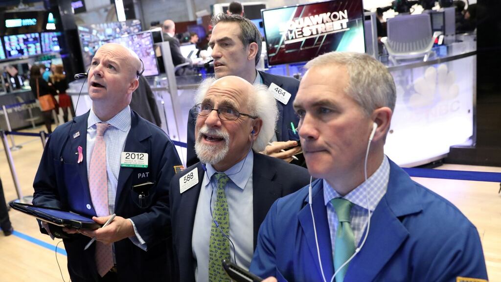 Traders working the floor of the New York Stock Exchange. The S&P 500 notched a fresh record high on Wednesday as gains in Apple’s shares powered a rally in tech stocks. Photograph: Reuters