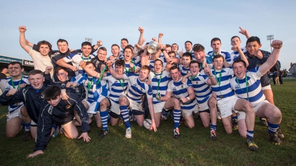 Garbally College’s captain Simon Keller leads the celebrations with the trophy and his team-mates after they had beaten Summerhill College at the Sportsground. Photograph: James Crombie/Inpho