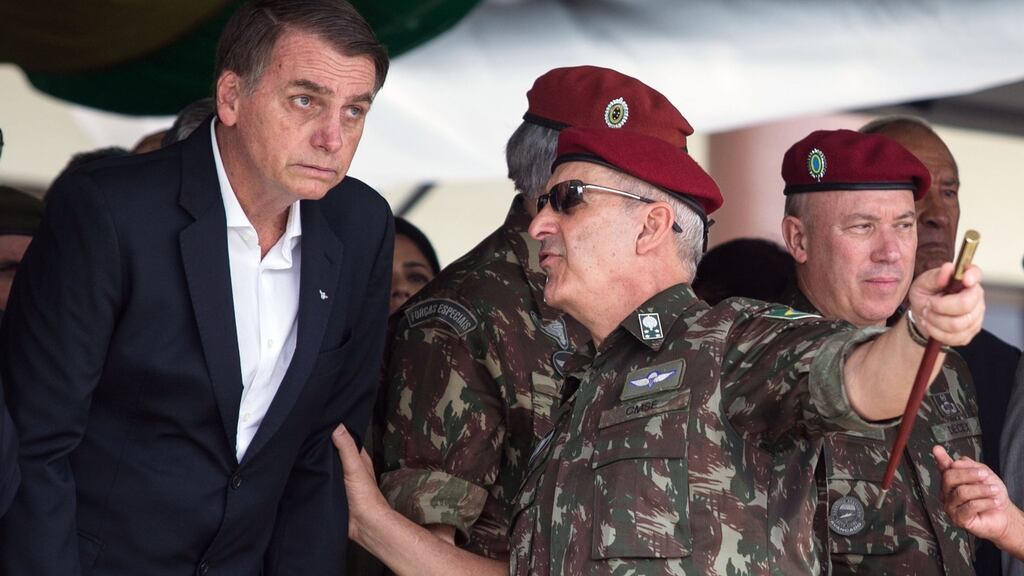 Brazilian president Jair Bolsonaro speaks to army general Luiz Eduardo Ramos Baptista Pereira: the generals have been serially humiliated by the president and his sons. Photograph: Fernando Souza/AFP/Getty