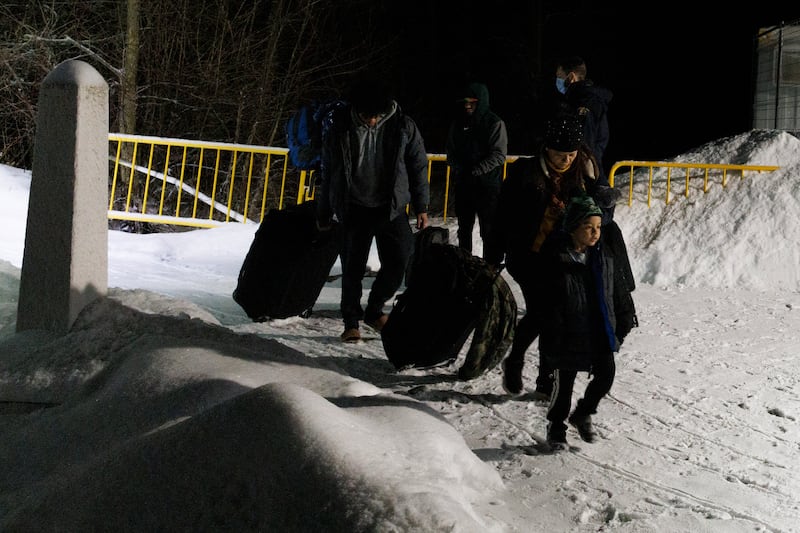 Migrants arriving at the Roxham Road border crossing from New York City head indoors for processing in Saint-Bernard-de-Lacolle. Photograph: Nasuna Stuart-Ulin/New York Times