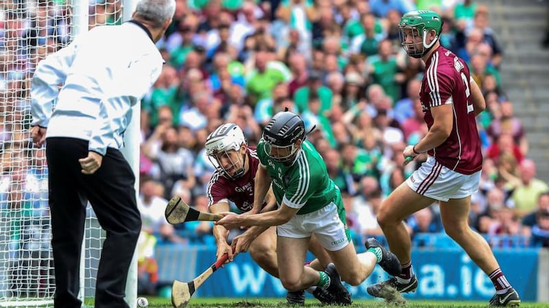 Galway’s Daithí Burke is unable to stop Graeme Mulcahy of Limerick scoring a goal. Photograph: Bryan Keane/Inpho