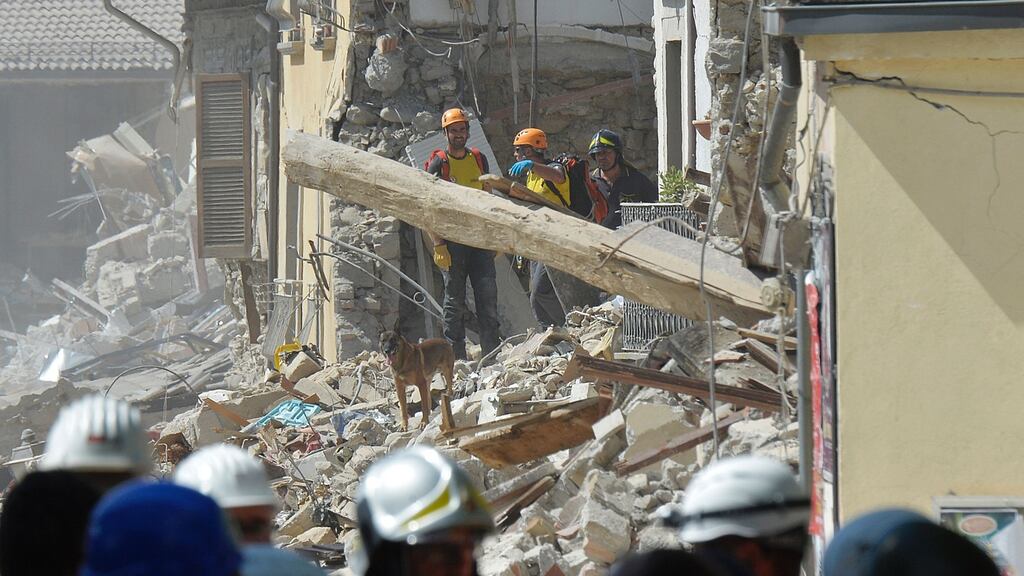 Rescue workers search through the rubble of an earthquake damaged building in the central Italian village of Amatrice on Friday. Photograph: Andreas Solaroandreas/ AFP/Getty