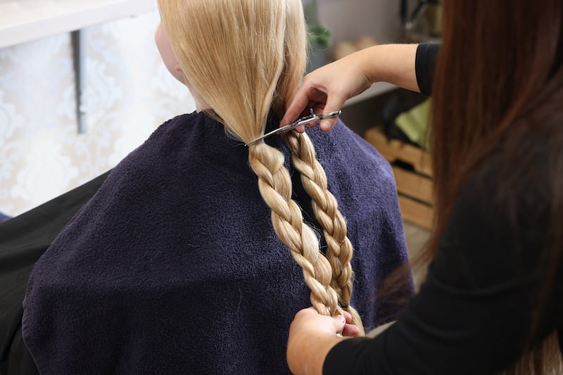 Sinead Campbell at Susan Collins Home of Hair in Greystones cuts Robyn's hair for the Rapunzel Foundation. Photograph: Dara Mac Dónaill