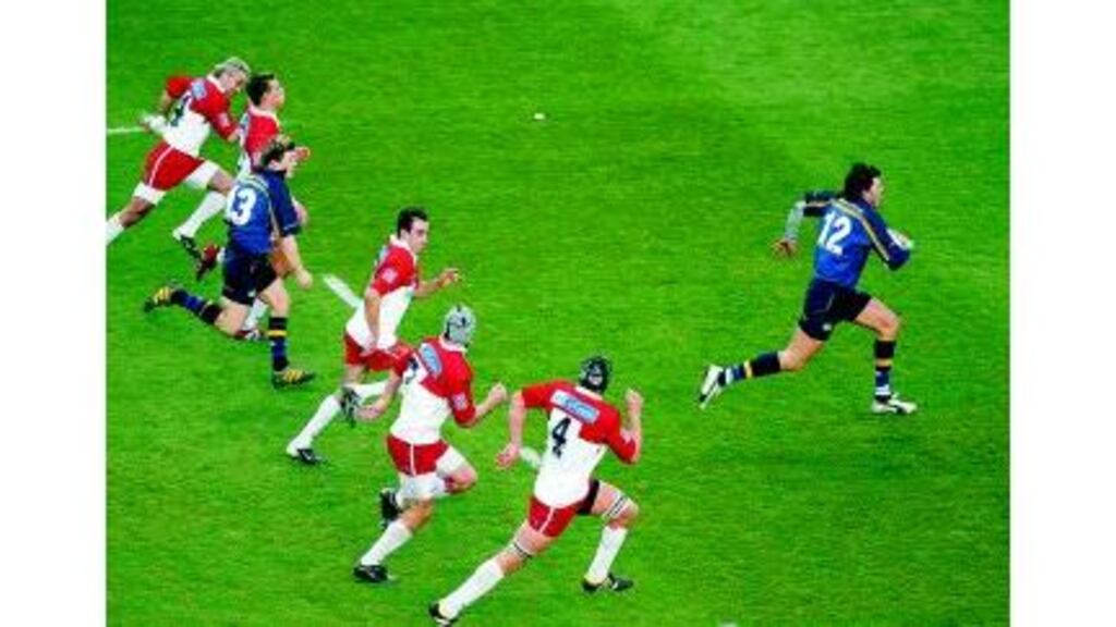 Shane Horgan smashes through the Biarritz cover to race away for a try in Leinster' Pool Three encounter with the French side at Lansdowne Road last December