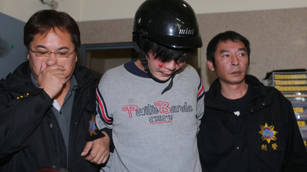 Police escort a man accused of attacking and murdering a young girl with a cleaver on a street in Taipei, Taiwan. Photograph: Aden Hsu/AFP Photo