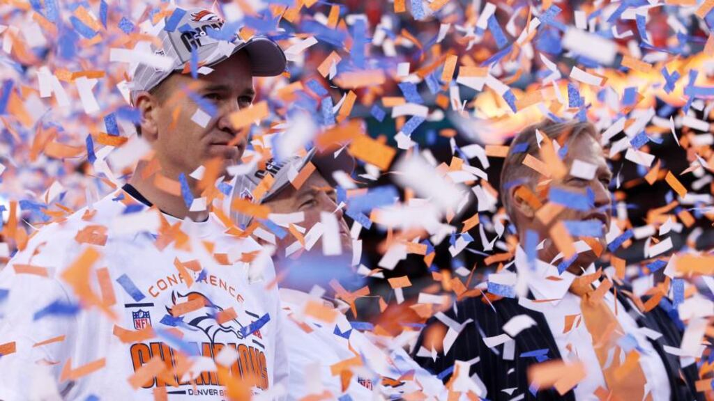 Denver quarterback Peyton Manning , head coach John Fox and former player John Elway celebrate after their AFC Championship game victory over the New England Patriots at Sports Authority Field in Denver, Colorado. Photograph: Doug Pensinger/Getty Images