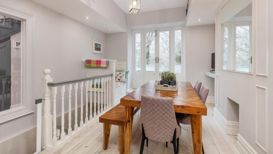 The stairs from the dining room makes the living room very accessible.