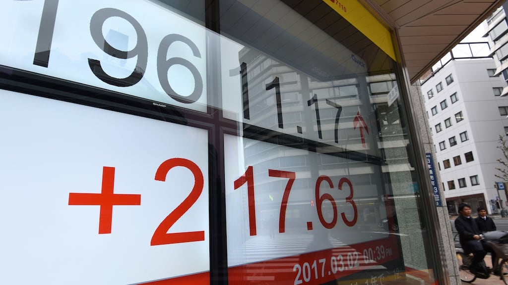 The Tokyo Stock Exchange in front of a securities company: Tokyo stocks rose during the morning trading based on renewed hopes for US president Donald Trump’s economic growth plans. Photograph: Toru Yamanaka/AFP/Getty Images