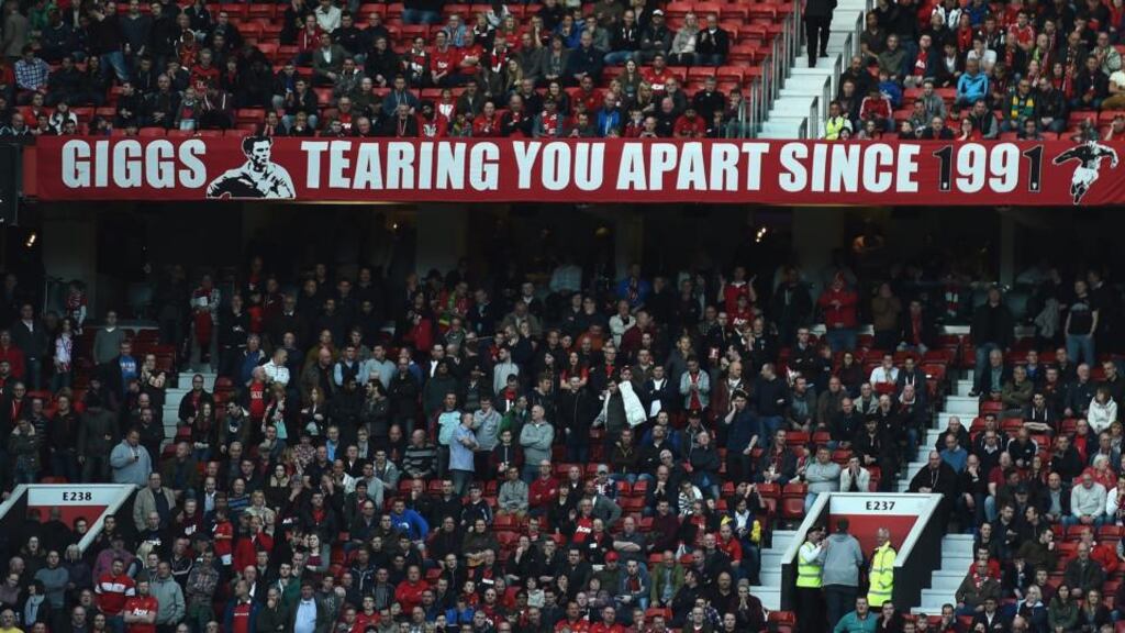 A banner showing support for Ryan Giggs during the  Premier League match between Manchester United and Norwich City at Old Trafford. Manchester United  paid €87 million in interest and other finance costs in 2012-13.  Photo:  Laurence Griffiths/Getty