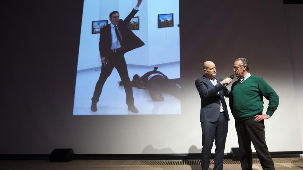 Winner of the World Press Photo 2016 Burhan Ozbilici (right) with Lars Boering, managing director of the World Press Photo Foundation. Behind them is the winning image. Photograph: Getty Images