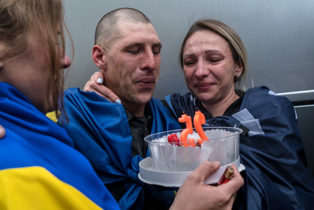 Yurii Dobriev, a Ukrainian National Guard soldier just released from Russian captivity, blows out candles for his 25th birthday, which passed in April, with his sisters Anastasiia Dobrieva, left, and Inha Palamarchuk at a reception point in the Chernihiv region of Ukraine, on Tuesday, May 6th. Photograph: Brendan Hoffman/New York Times