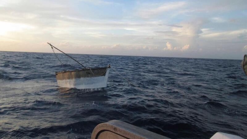 A boat that left Cuba with 32 migrants aboard is towed to shore by the Mexican Navy. Seventeen of the group of 32 Cuban migrants did not complete the journey. Photograph: SEMAR/Handout via Reuters.