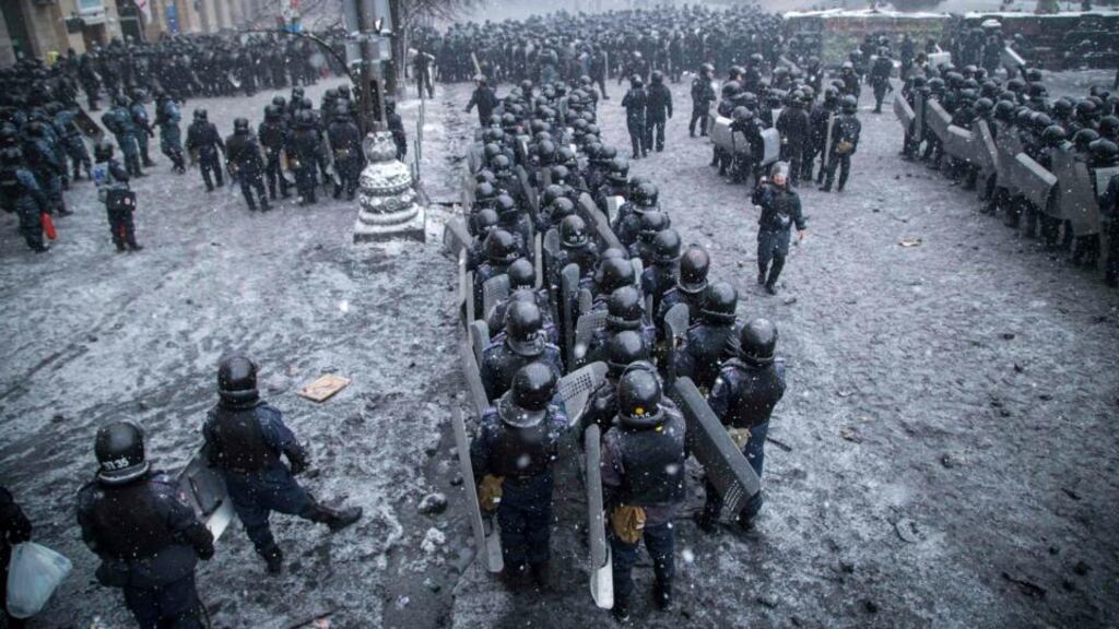 Riot police and interior ministry members stand in formation during clashes with pro-European protesters in Kiev yesterday. Photograph: Reuters/Stringer