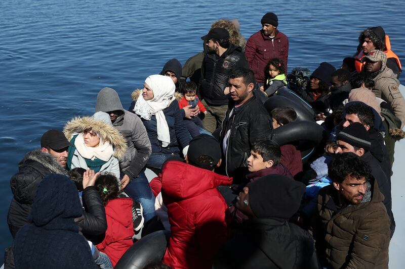Asylum seekers are prevented from disembarking from a dinghy after they arrived at the small port of Thermi with the help of a life guard vessel on Lesvos island, Greece on Sunday. Photograph: Orestis Panagiotou/EPA