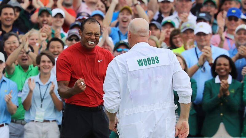 Tiger Woods  celebrates with caddie Joe LaCava  on the 18th green after winning during the  Masters at Augusta National Golf Club. Photograph: David Cannon/Getty Images