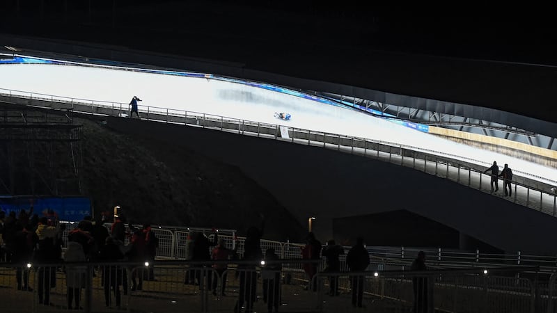 People watch the men’s single race during the FIL Luge World Cup, part of a 2022 Beijing Winter Olympic Games test event, at the Yanqing National Sliding Center in Beijing. Photograph: Wang Zhao/AFP via Getty