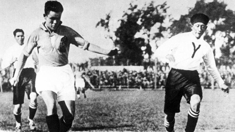 Yugoslavia’s Alexander Tirnantich, left, causes problems for the Bolivian defence. Photo: Popperfoto/Getty Images