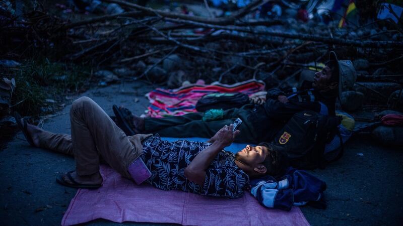 Supporters of Evo Morales resting near a barricaded road outside Cochabamba, Bolivia. Photograph: Federico Rios/The New York Times