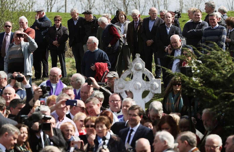 NO SWANSONG: Mourners watch as a sing-song continues on the grounds of Saint Patrick's Church during Big Tom's funeral. Photograph: Brian Lawless/PA Wire