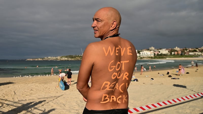 A man poses for a photo at Bondi Beach following its reopening to the public in Sydney, Australia, on Tuesday. Photograph: Joel Carett/EPA