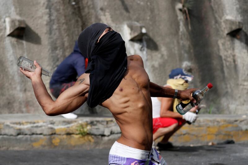 Demonstrators clash with Venezuelan national guards during a protest in Caracas. Photograph: Reuters/Carlos Garcia Rawlins
