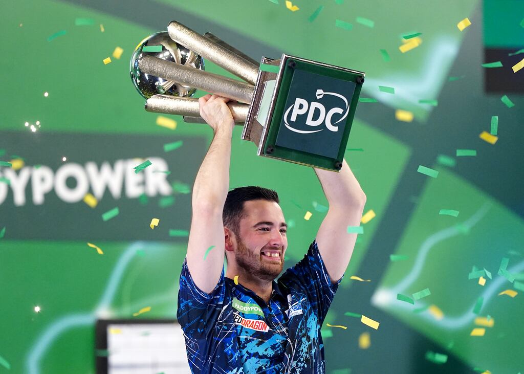 Luke Humphries celebrates with his trophy after beating Luke Littler in the final of the World Darts Championship. Photograph: Zac Goodwin/PA Wire