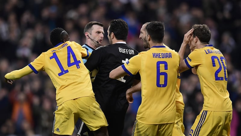 Gianluigi Buffon remonstrates with referee Michael Oliver after a penalty was awarded against Juventus in their Champions League quarter-final clash with Real Madrid. Photo: Getty Images