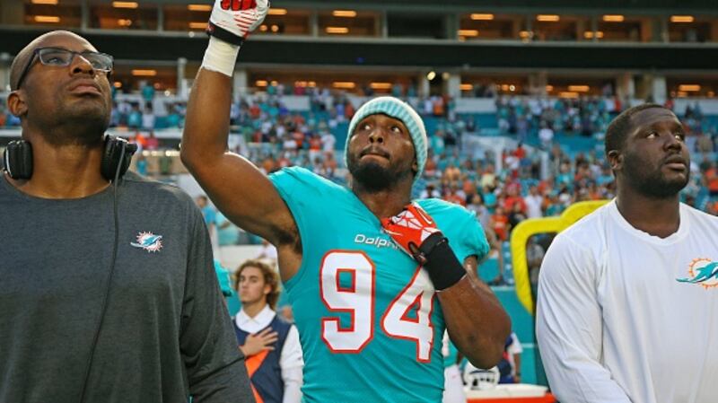 Miami Dolphins defensive end Robert Quinn raises his fist during the national anthem. Photograph: Getty Images