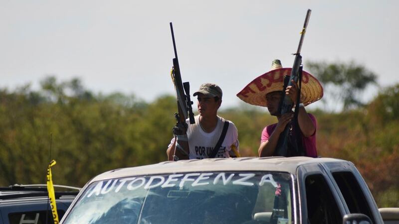 Vigilantes stand on a pick up truck on the outskirts of Paracuaro on January 10th. Mexico’s government on Monday pledged to take control of the violent western state of Michoacan after days of fighting between masked vigilantes and members of one of the country’s most powerful drug cartels. Photograph: Alan Ortega/Reuters